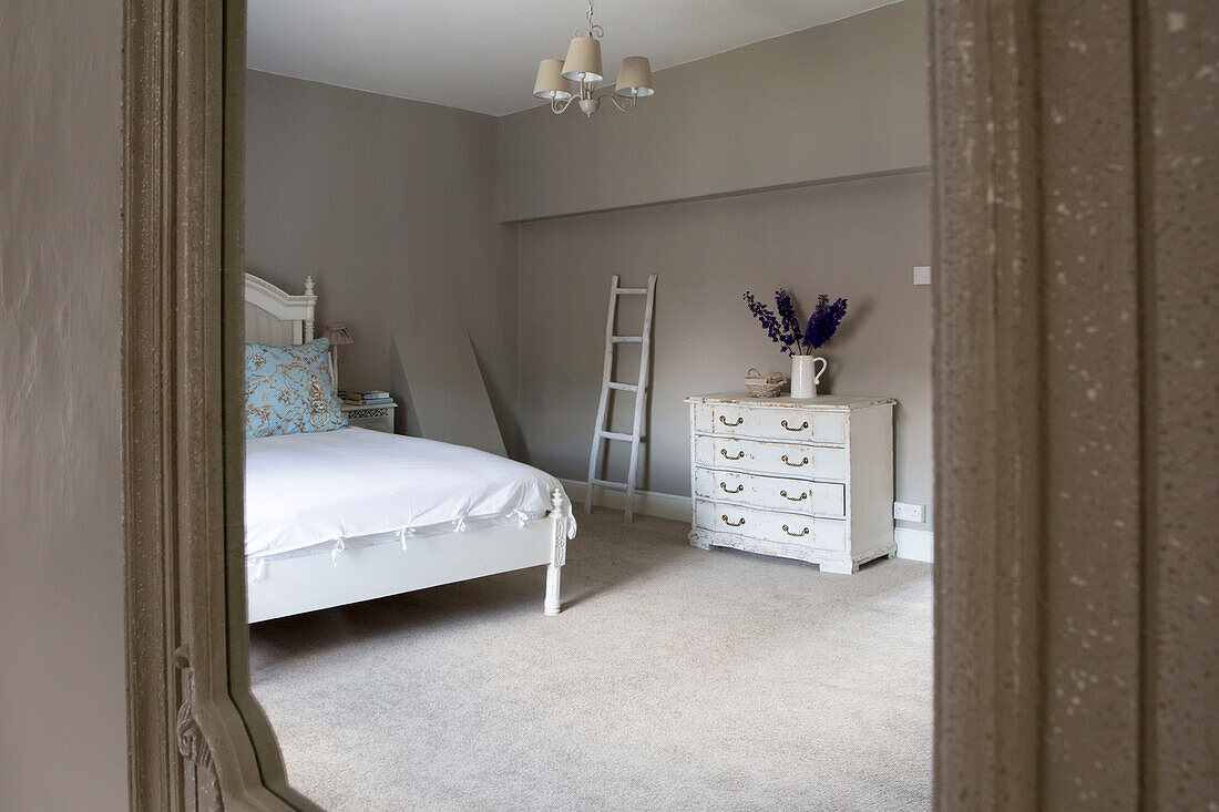 Chest of drawers and ladder reflected in bedroom mirror of Petworth farmhouse West Sussex Kent