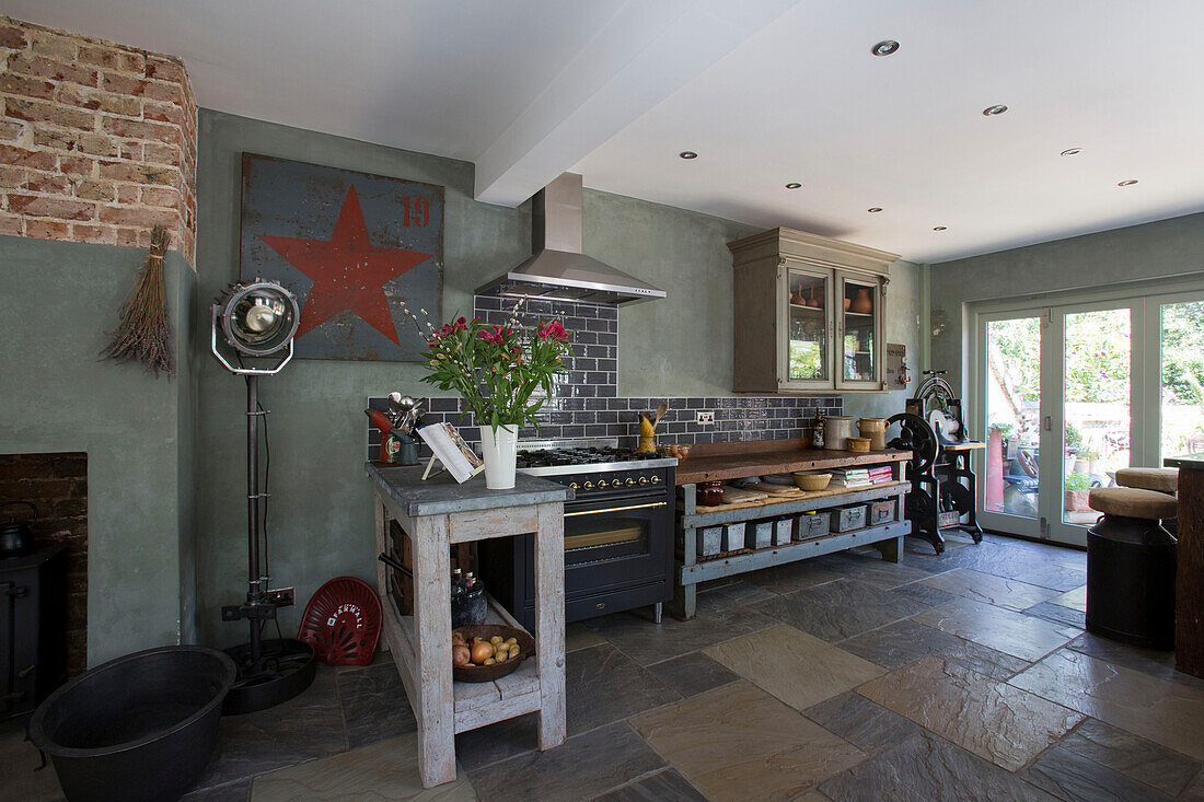Open-plan kitchen/diner with zinc work-surfaces in Edwardian West Sussex townhouse England UK