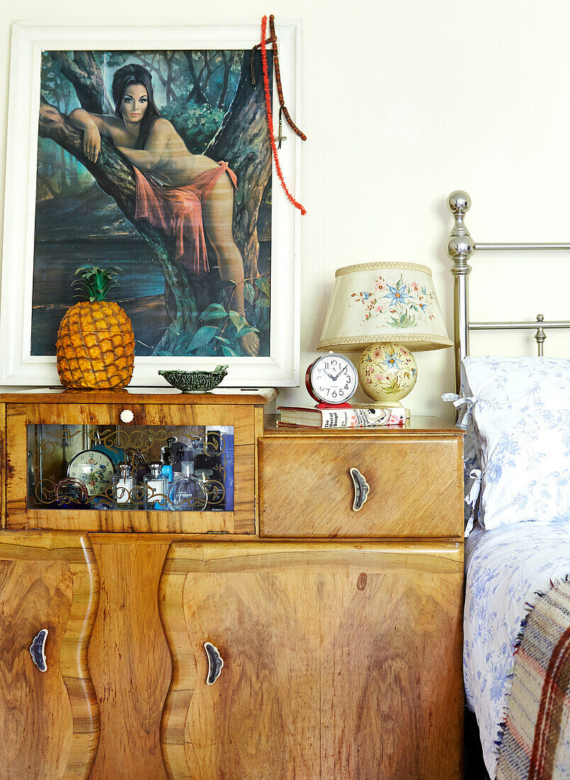 Ornaments on vintage wooden bedside cabinet in Brabourne farmhouse,  Kent,  UK