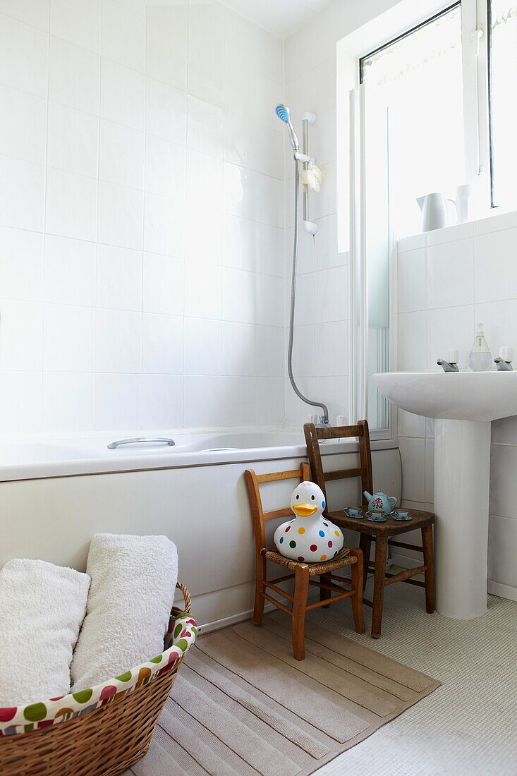 Toy duck on wooden chair in bathroom of London family home  England  UK