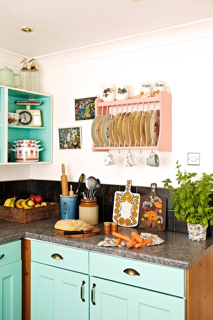 Retro style kitchenware and plate rack in kitchen of Birmingham home  England  UK