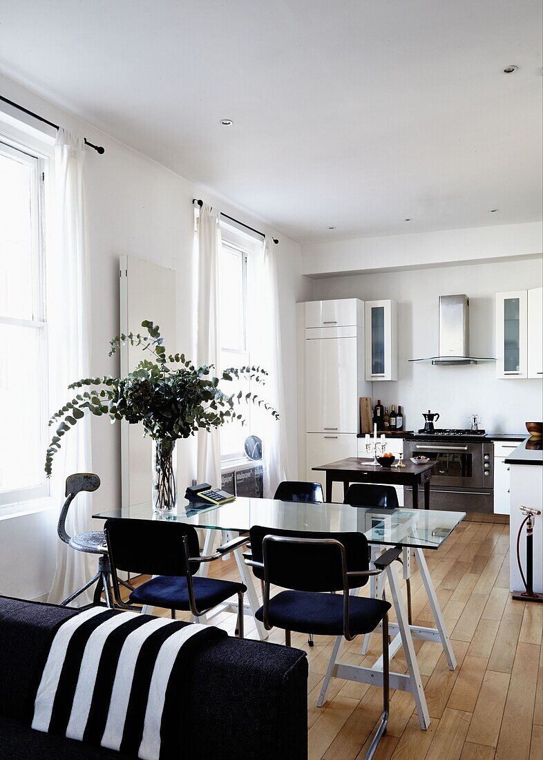 Open plan kitchen and dining room with leaf arrangement in contemporary London home   England   UK