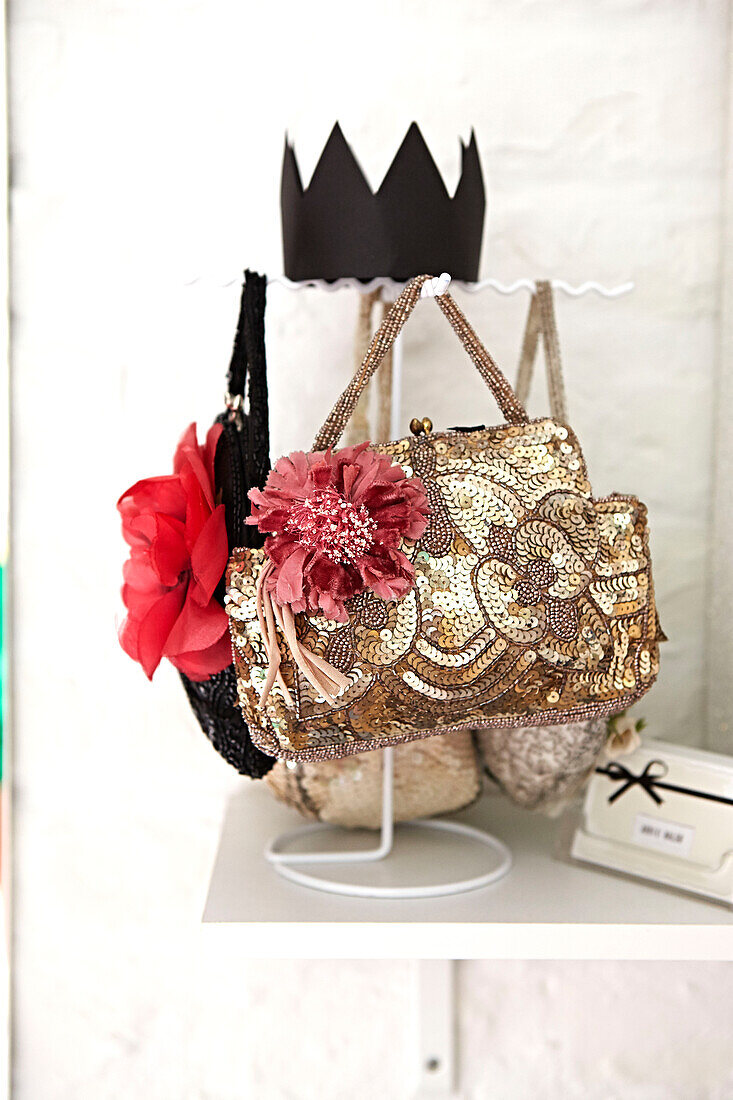 Floral accessories on gold sequinned handbag in Faversham home,  Kent,  UK