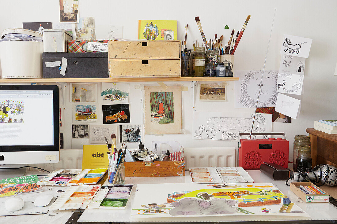 Art equipment and computer screen with radio on desk in Berwick Upon Tweed home  Northumberland  UK