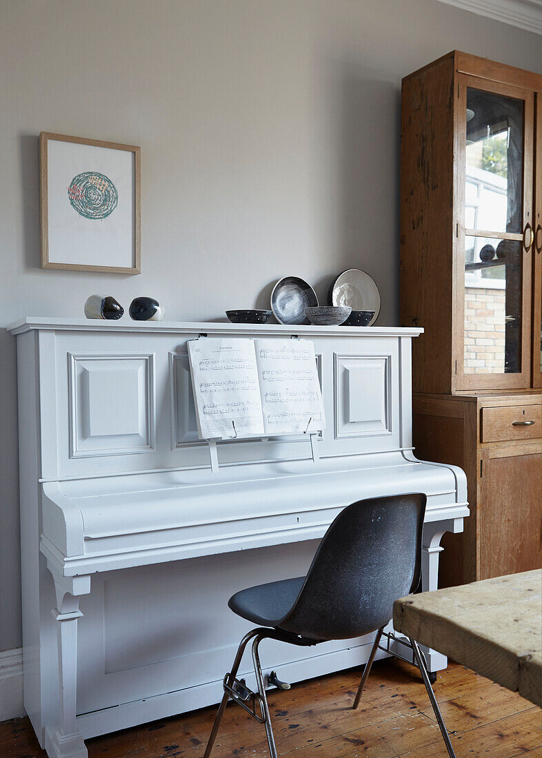 Black chair at piano with sheet music in Sheffield home  Yorkshire  UK