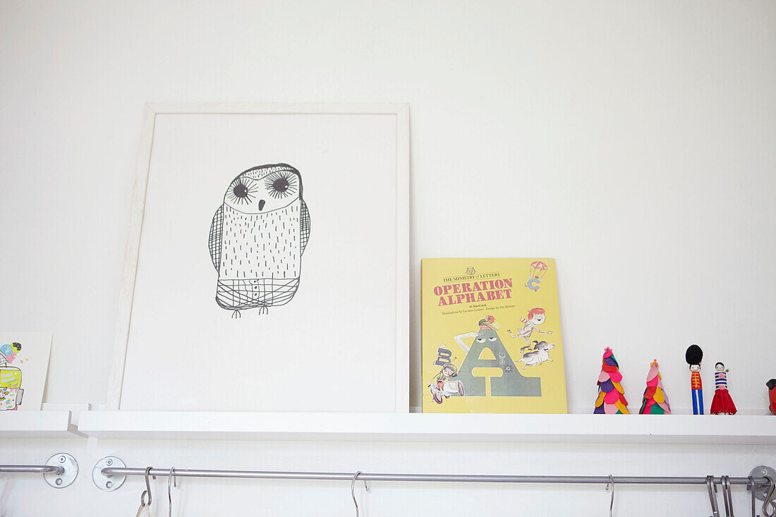 Framed owl and toys on shelf in child's room of Sheffield home  Yorkshire  UK