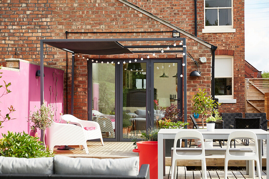 Decked terrace with awning in garden of modernised Victorian Preston home  Lancashire  England  UK