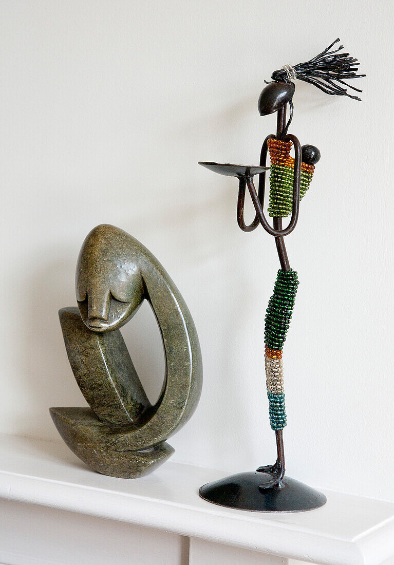 Two tribal ornaments on dining room shelf in ?New Malden home, Surrey, England, UK