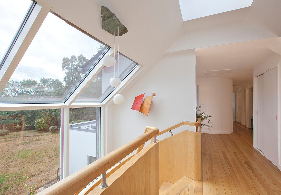 Wooden landing with large windows in modern Essex home UK