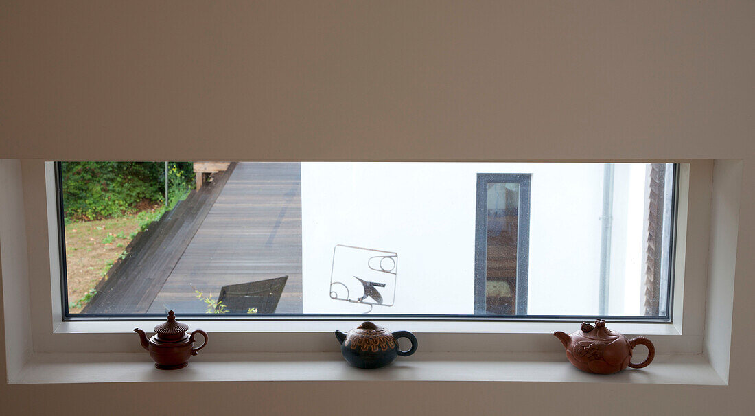 Oriental teapots on windowsill in Essex home UK