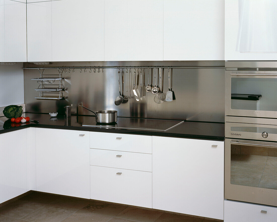 Modern white fitted kitchen with marble worktop