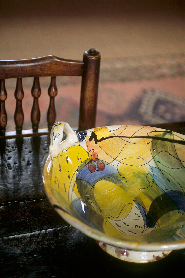 Still life of kitchen chair and ceramic bowl