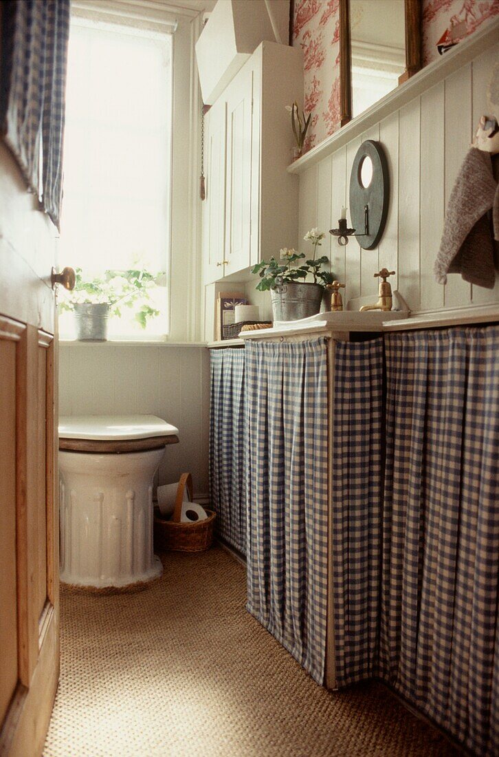 Downstairs toilet and cloakroom with curtained units