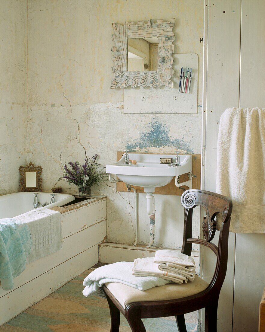 Poetic white bathroom with mahogany chair