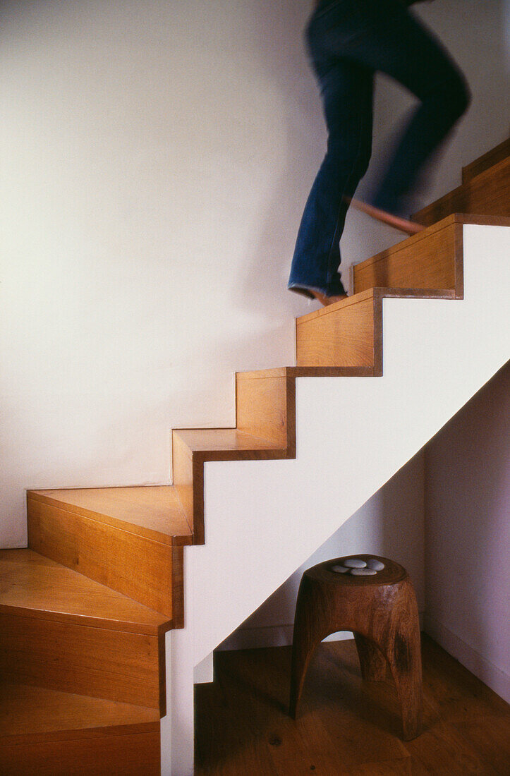Woman walking up modern staircase