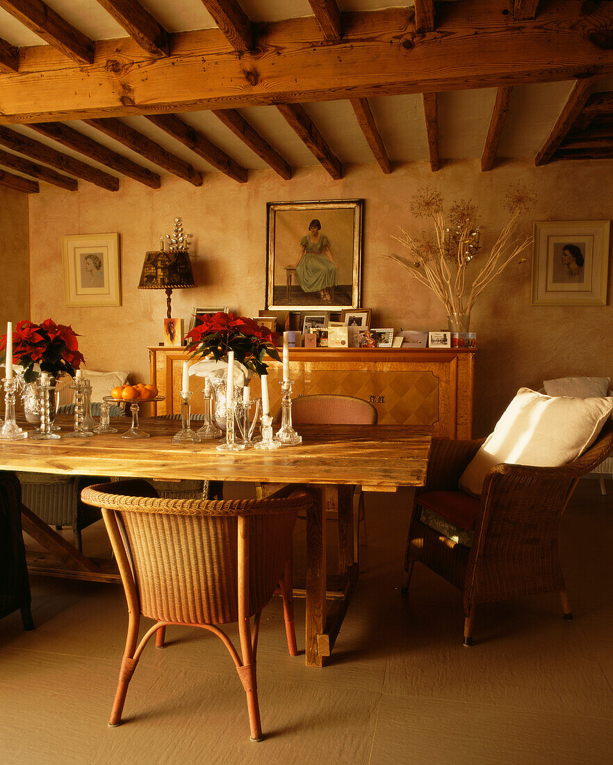 Dining room over table and veneered 1940s French sideboard with vintage glass picture frames and portrait of the girl in a green dress