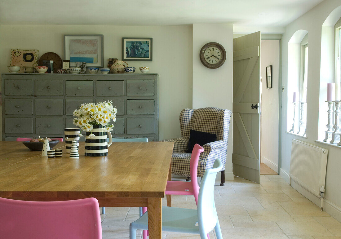 Jug of daisies on wooden table in kitchen of Devon mill conversion