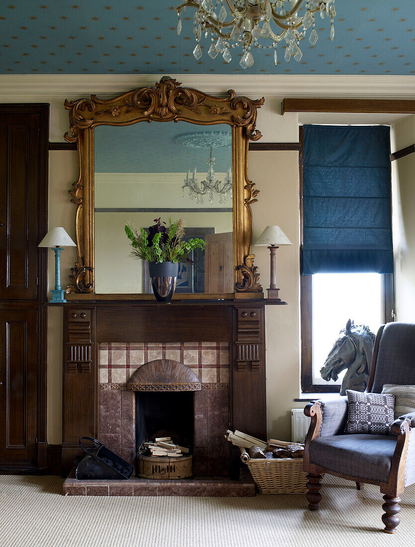 Warm brown and gold and rich blues and greys are the colours in the living room with blue and gold star wallpaper on the ceiling