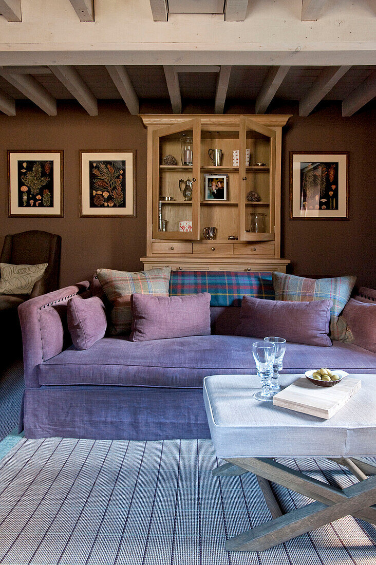 Open dresser and sofa in beamed living room Wiltshire