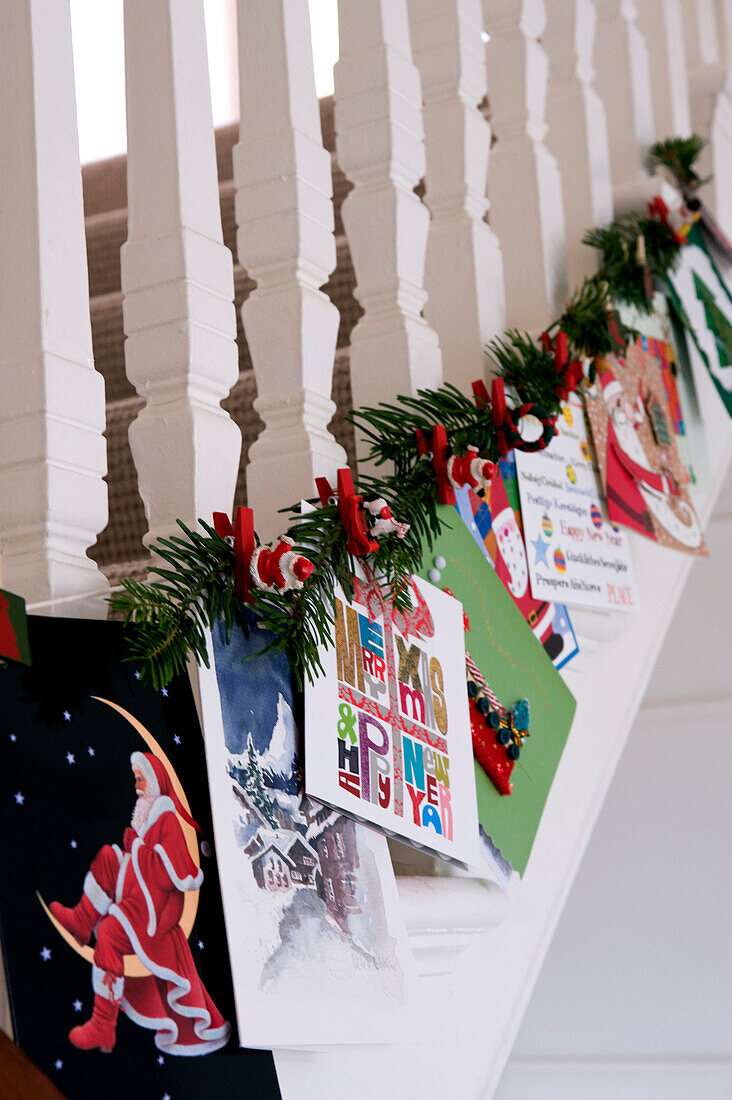 Staircase banisters decorated with Christmas decorations and cards