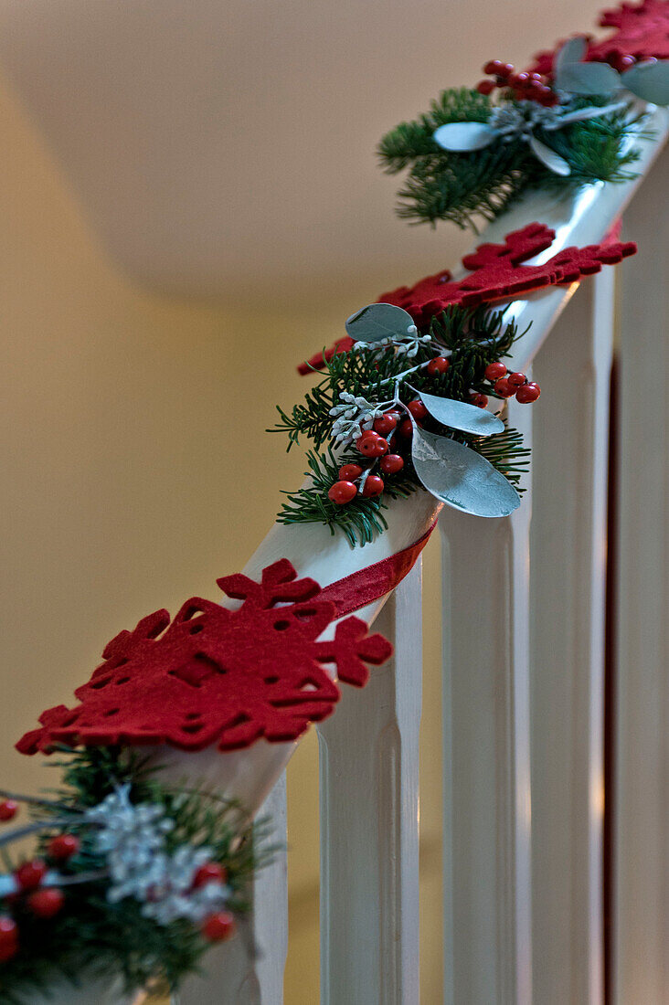 Handmade Christmas decorations on banister in London home UK