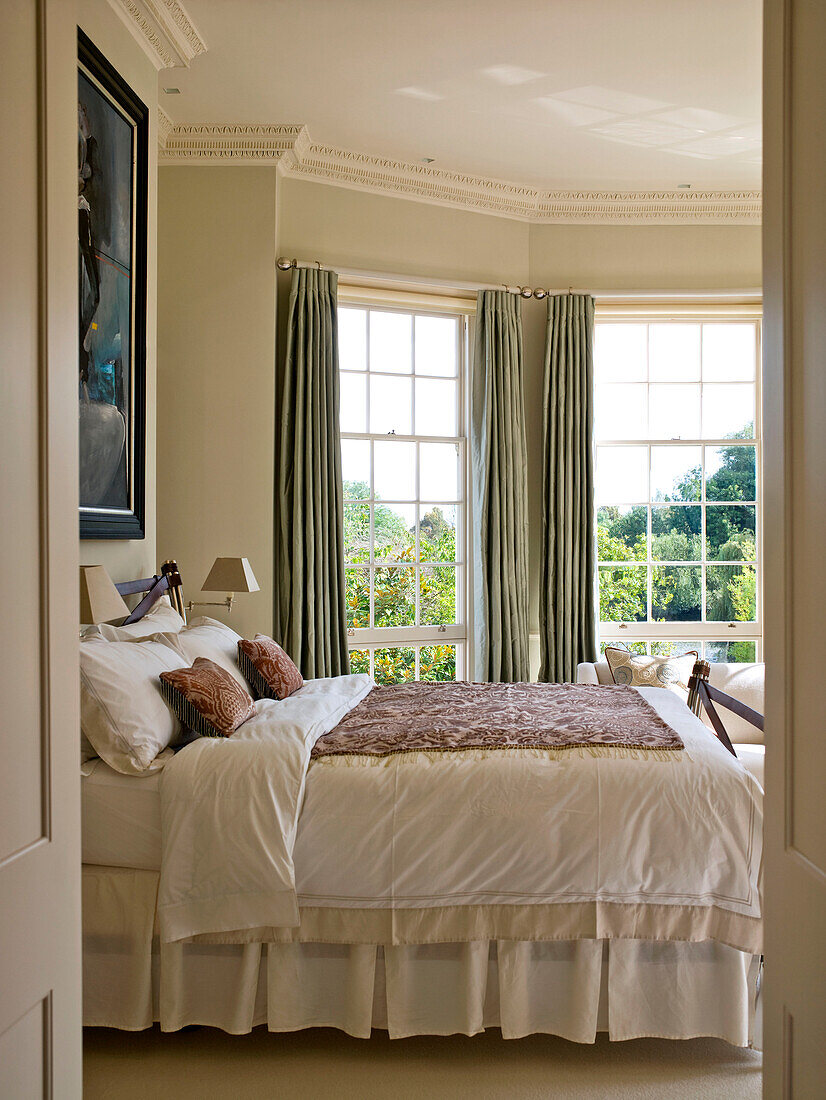 View through doorway to master bedroom of West London townhouse England UK