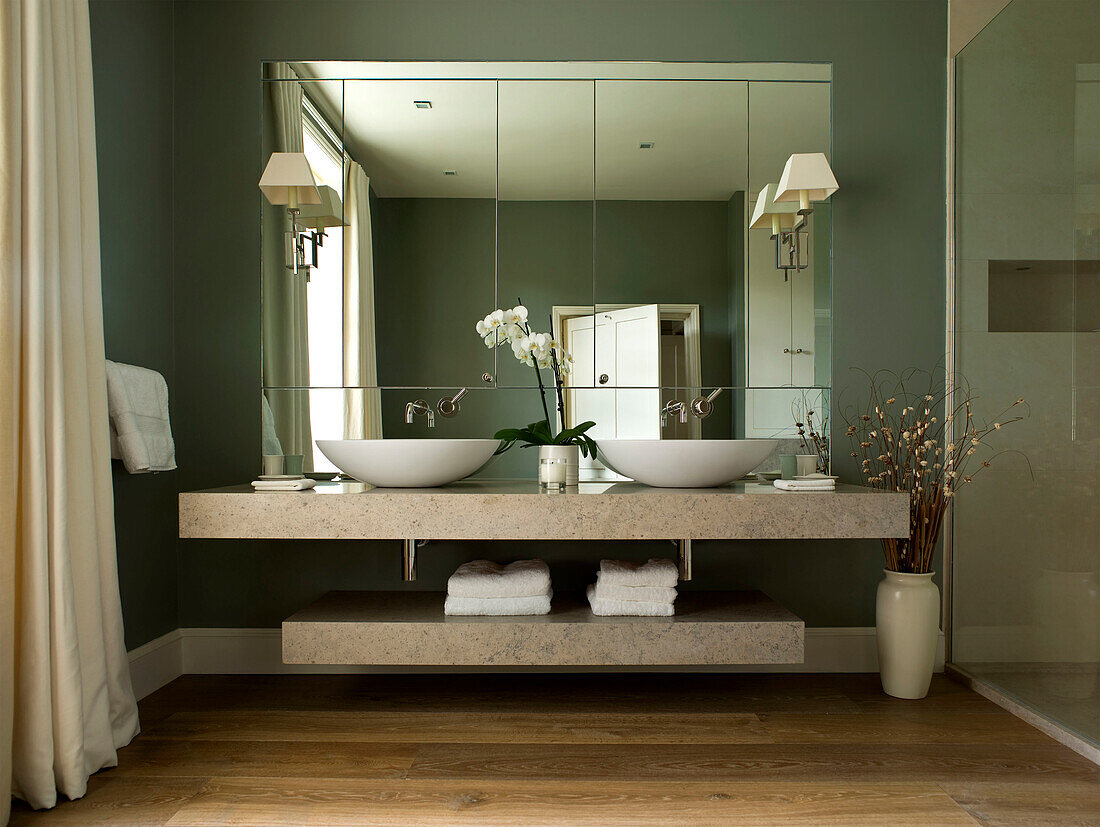 Mirrored bathroom with double basins in West London townhouse England UK