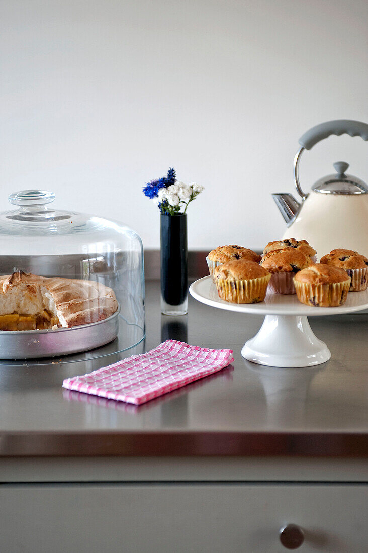 Cupcakes and meringue with kettle on work surface in Suffolk kitchen England UK