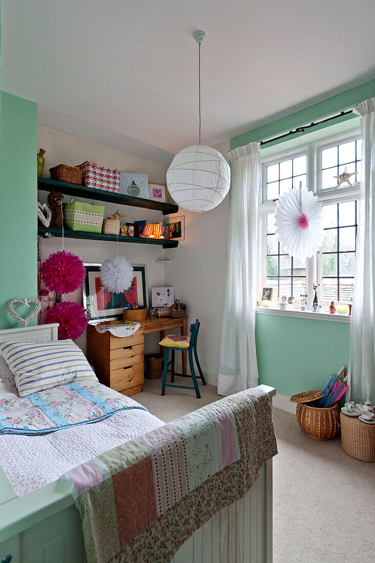 Patchwork quilt on footboard in childs bedroom of Forest Row family home, Sussex, England, UK