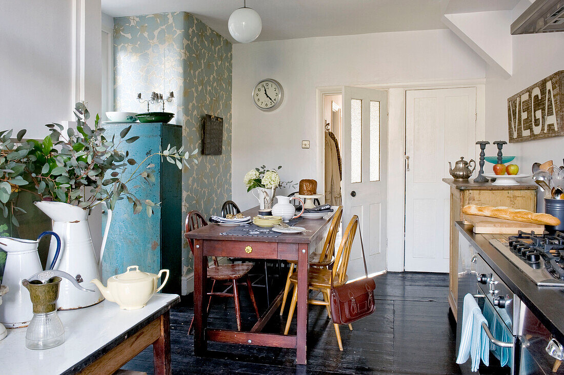 School bag on chair at kitchen table in contemporary London home, UK