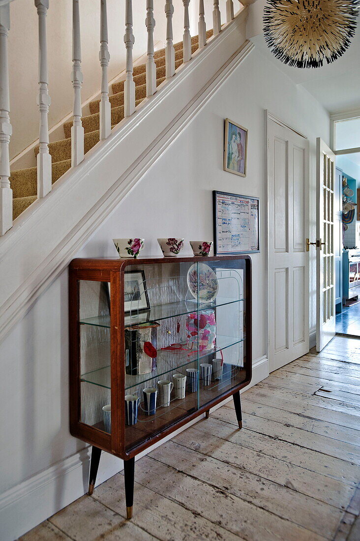 Vintage glass and wooden cabinet in family home, Bovey Tracey, Devon, England, UK