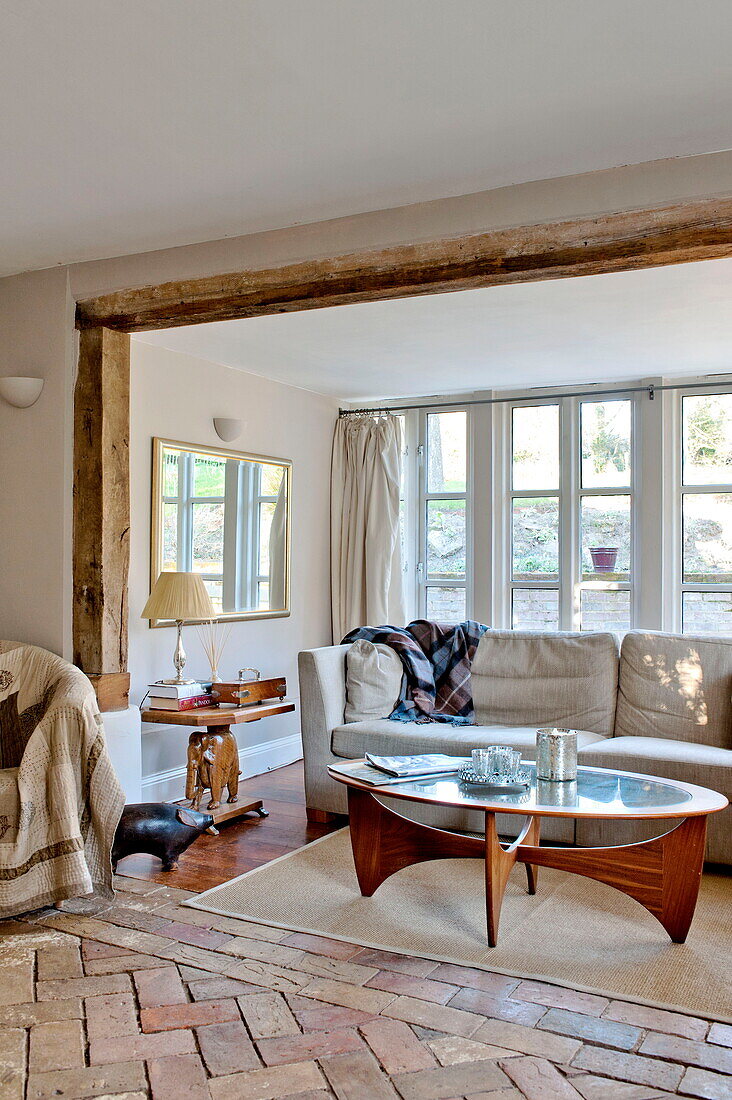Timber framed window recess with sofa and table in Suffolk farmhouse, England, UK