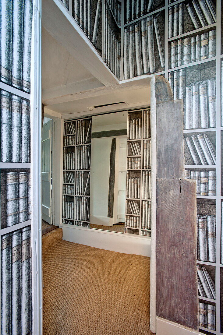 Trompe d'oeil wallpaper in seagrass hallway of Suffolk farmhouse, England, UK