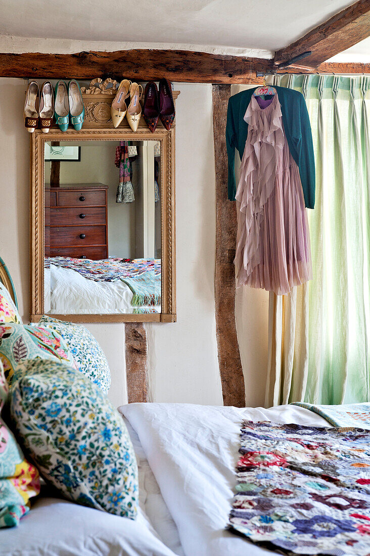 Gilt framed mirror with shoes in bedroom of Hertfordshire home, England, UK