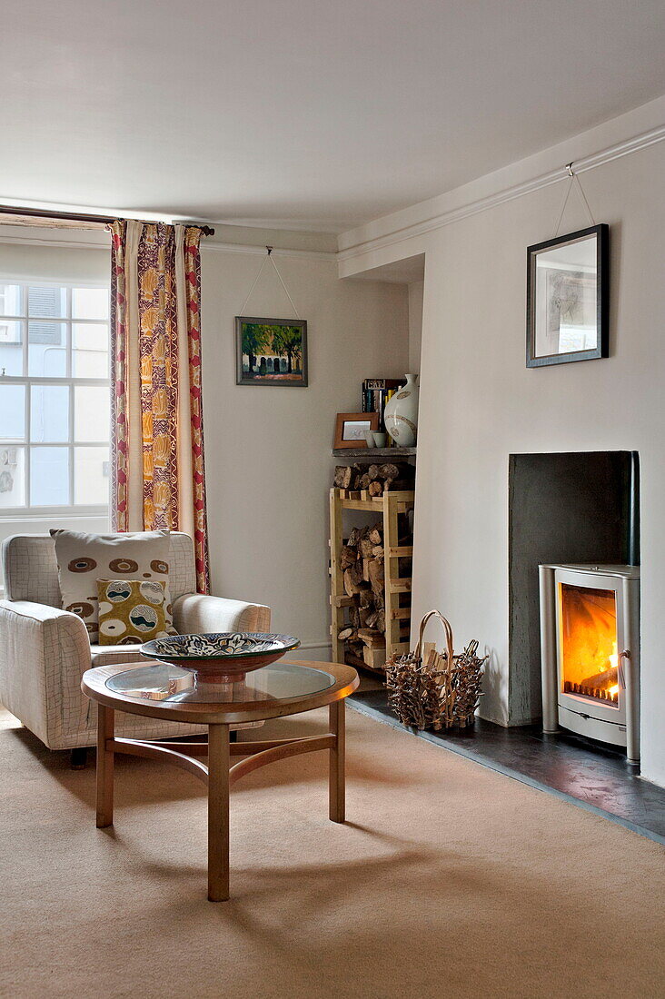 Retro armchair and 1940's style coffee table in living room of Padstow cottage, Cornwall, England, UK
