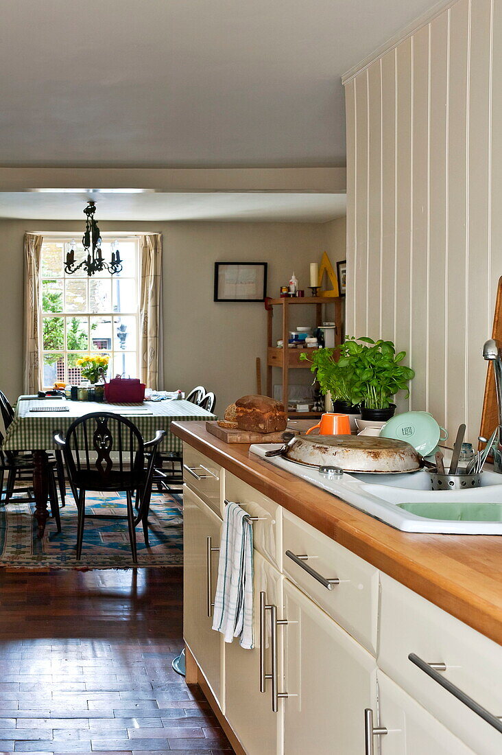 Clean washing up on kitchen draining board in Padstow cottage, Cornwall, England, UK