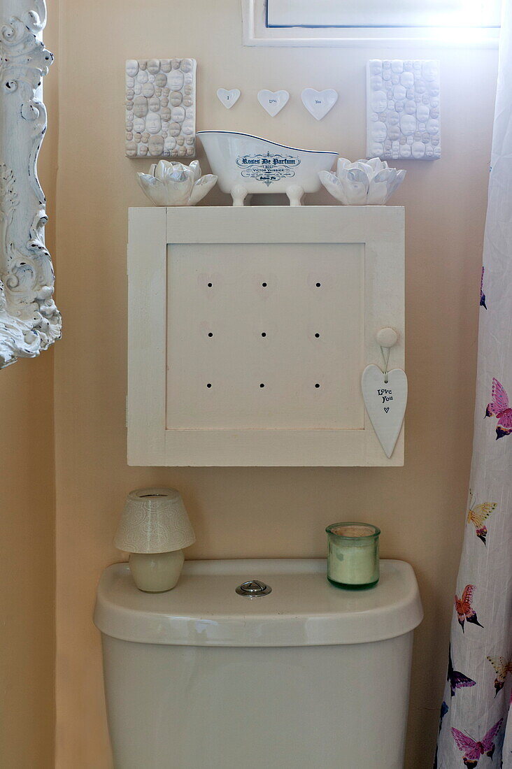 Bathroom cabinet with heart-shaped ornaments in London home, England, UK