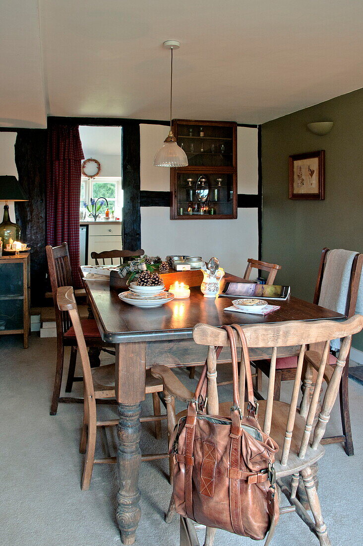 Wooden dining table and chairs in Shropshire cottage, England, UK