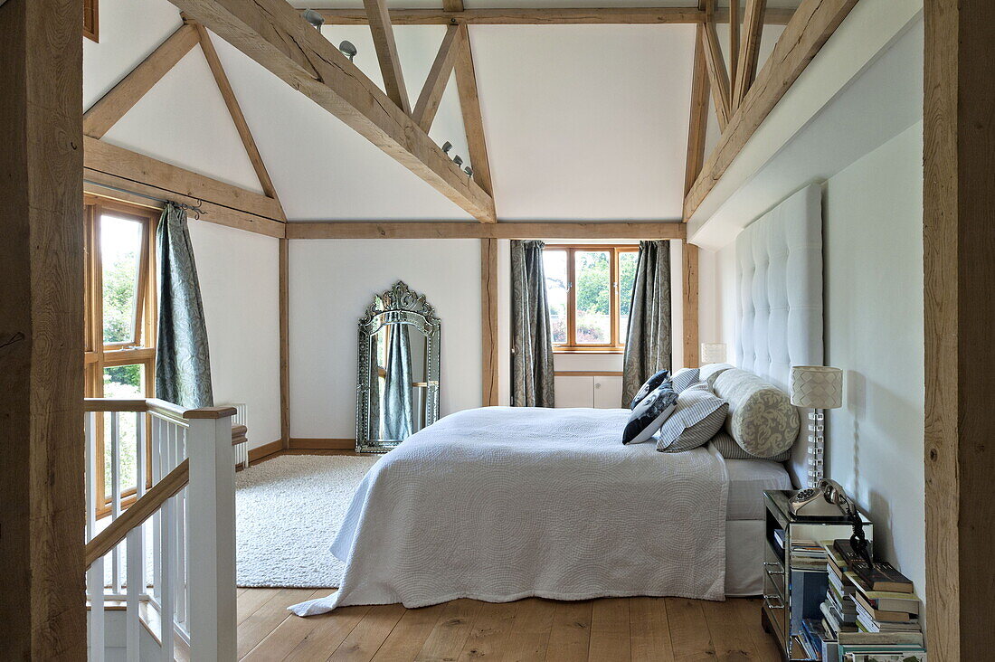 Double bed in contemporary beamed Suffolk/Essex bedroom, England, UK