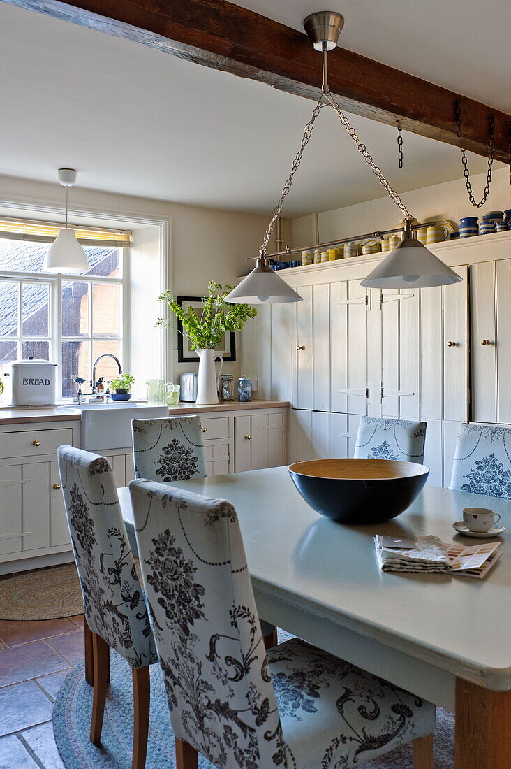 Upholstered kitchen chairs at table in Bury St Edmunds country home, Suffolk, England, UK