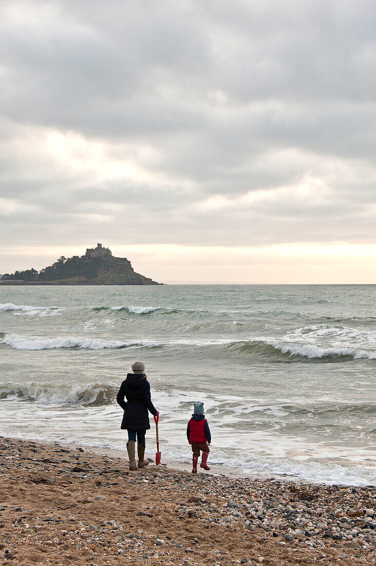 Mother and son walking on beach Penzance Cornwall England UK