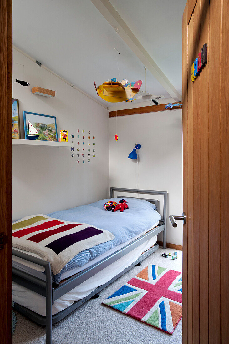 View through wooden door to boys room of Cornwall family home, UK