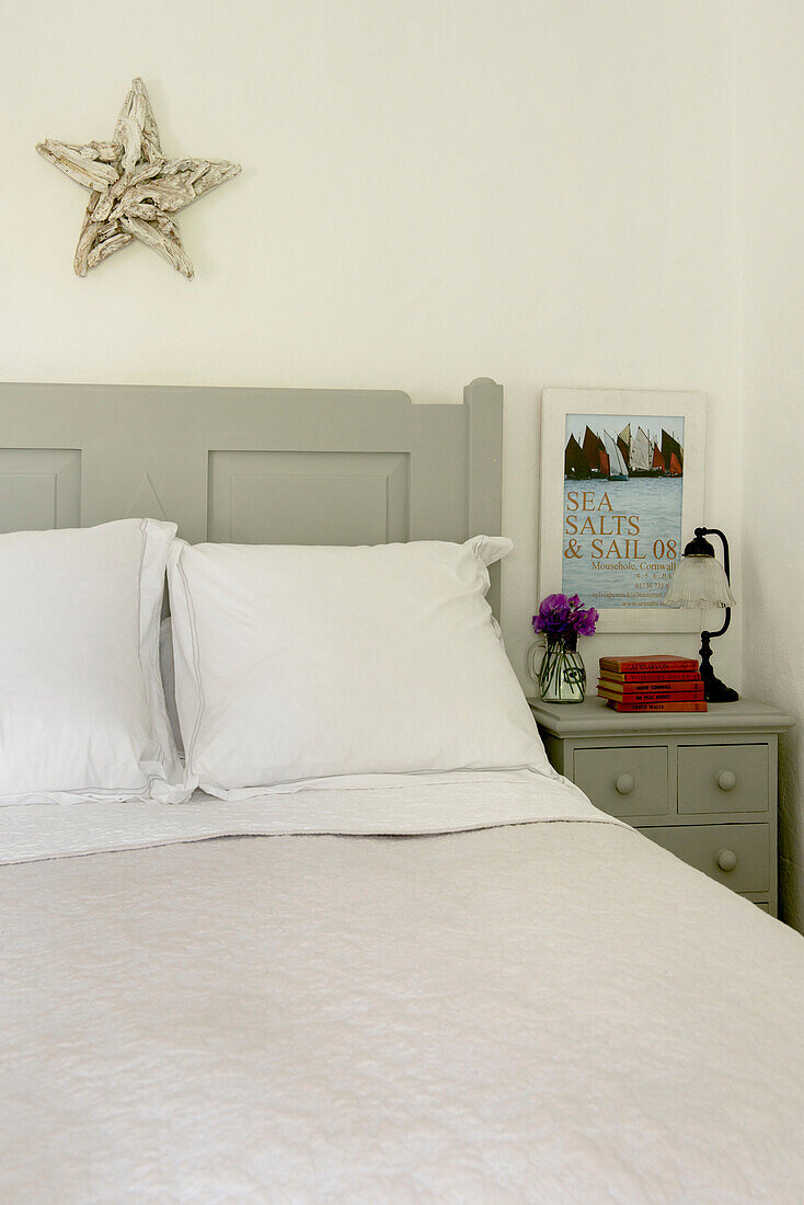 Star above double bed with painted cabinet in Penzance farmhouse Cornwall England UK