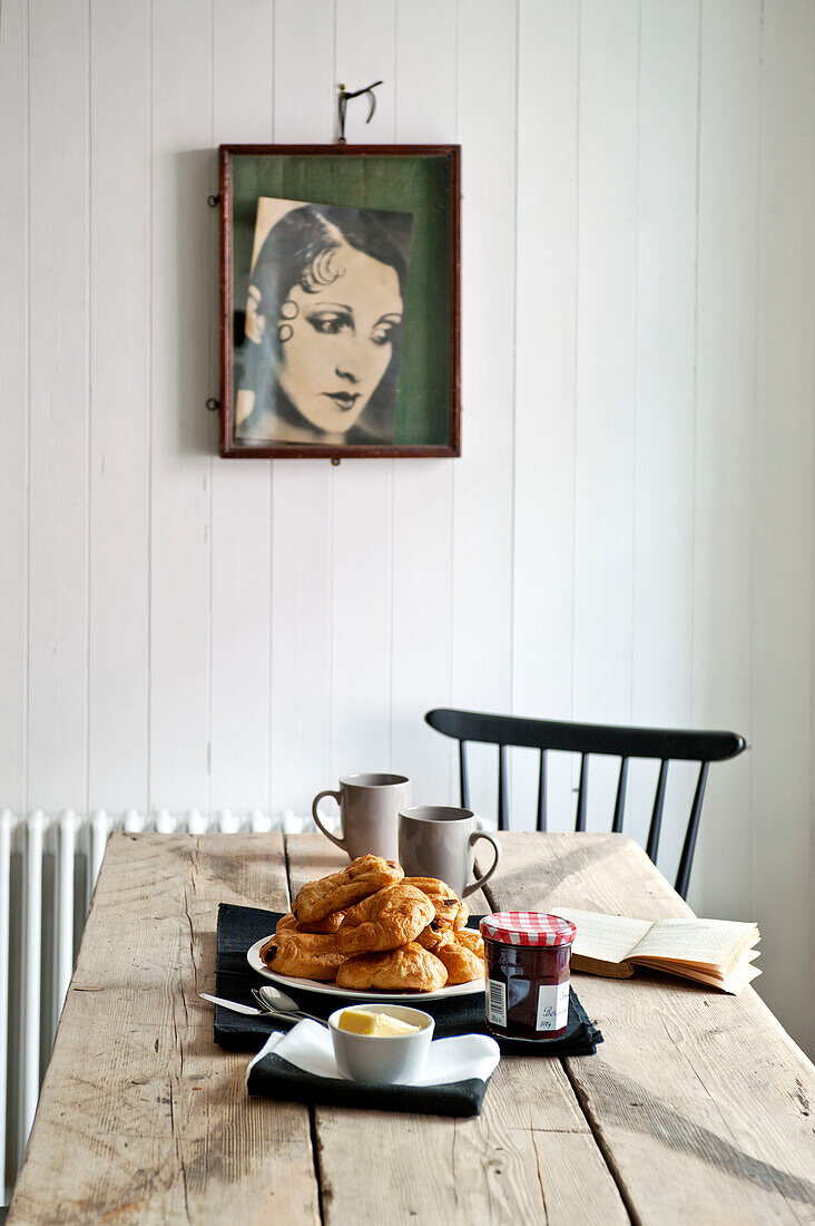 Croissants and jam with framed artwork in family townhouse Cornwall England UK