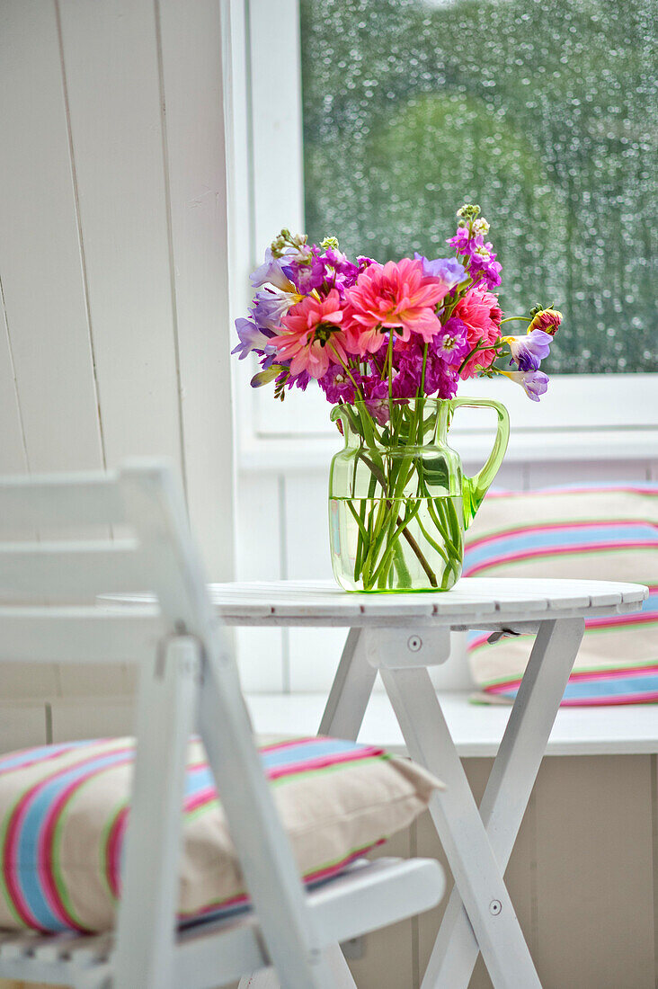 Cut flowers on table in attic conversion of family townhouse Cornwall England UK