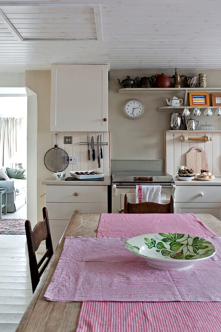 Bowl on table with red striped tablecloths in beach house Cornwall England UK