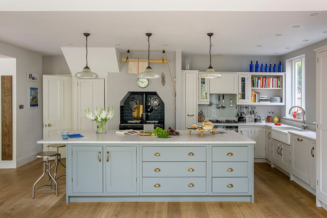 Light green fitted island unit in spacious Tunbridge Wells farmhouse style kitchen Kent England UK