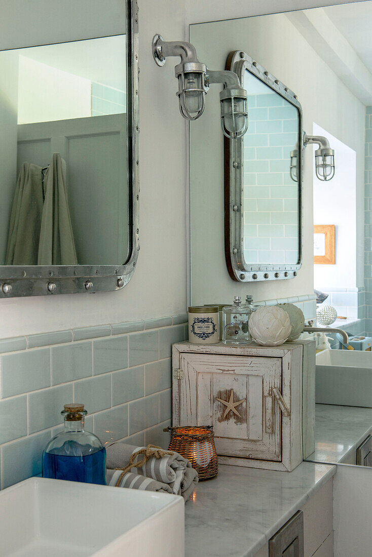 Silver mirror with rivets in nautically themed bathroom of Penzance home Cornwall UK