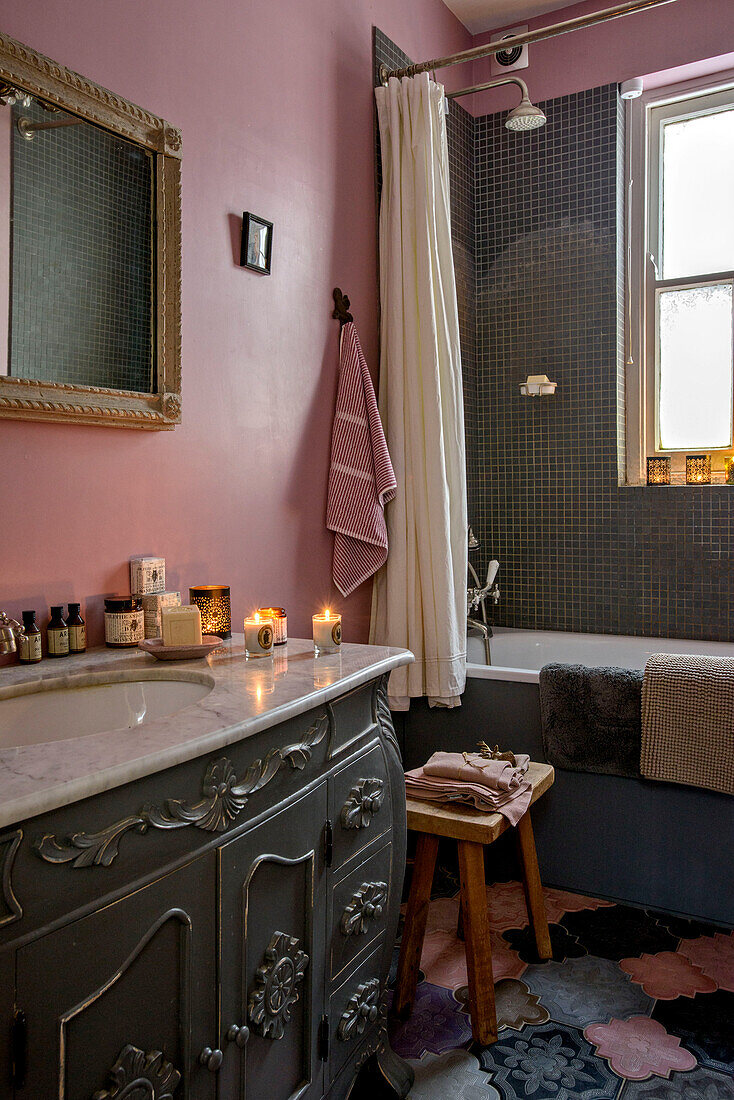 Marble topped wash stand in pink and grey bathroom of London home UK