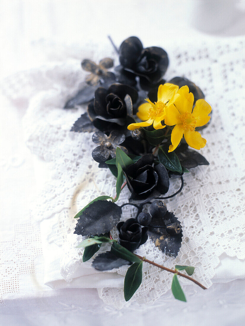 Yellow flowers on wreath of roses with lace